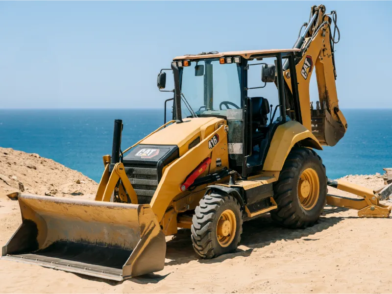 CAT 416 backhoe loader on a coastal job site in Los Cabos