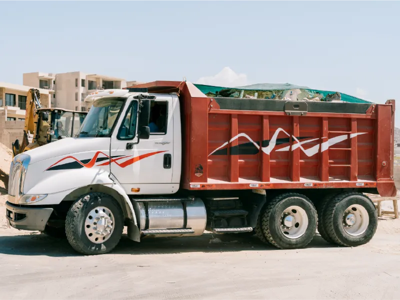 International TranStar dump truck with a red dump body on a Los Cabos site