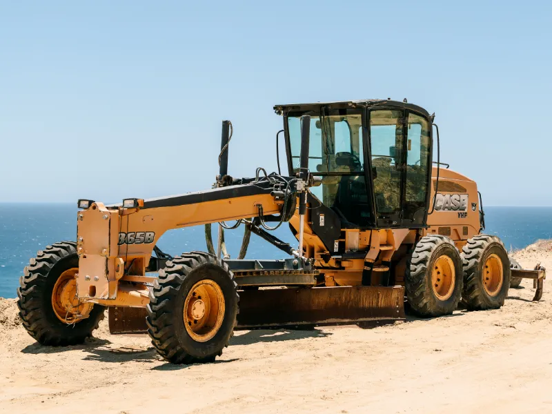 CASE motor grader on a graded lot overlooking the ocean